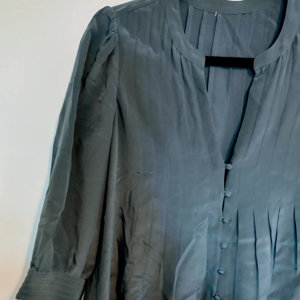 Blue top with front buttons. Tags have been removed. I believe it is jcrew size